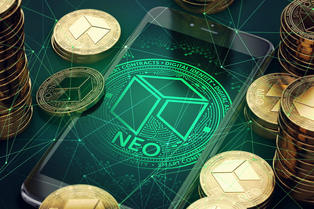 NEO physical coins on top of a mobile phone