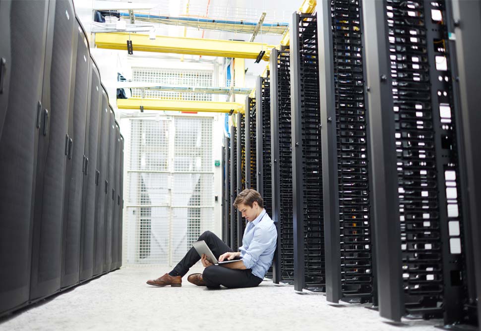 Guy sitting in server room